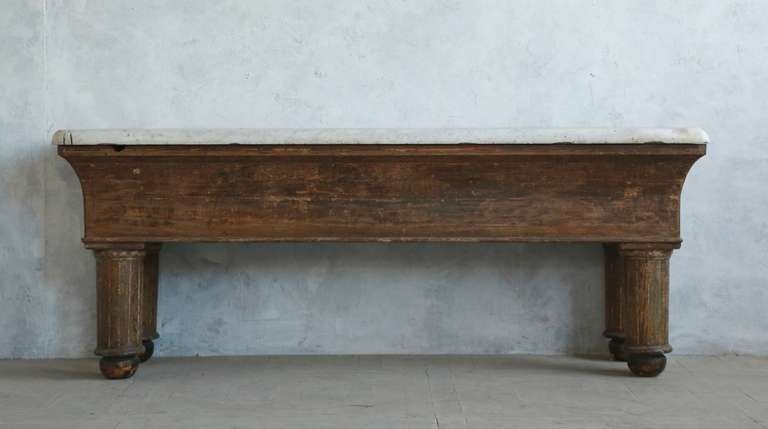 Incredibly cool antique oyster shucking table with amazingly distressed, chunky white slab marble top. There are remarkable signs of wear and use in the top, including an 