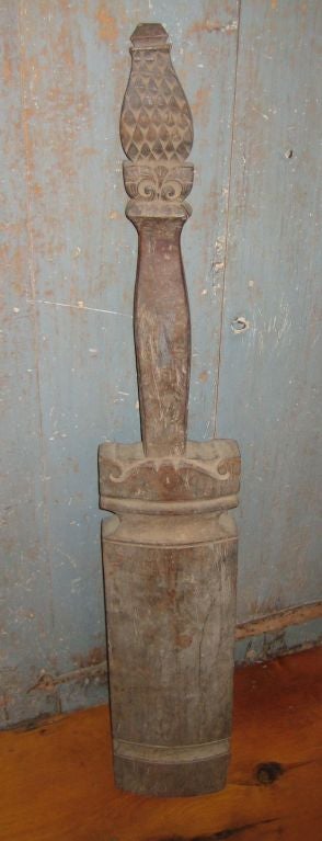 Tribal carved hardwood instrument with slit or slot to provide resonance