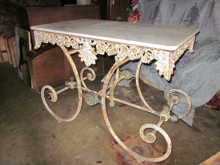 Cast iron French baker's table from the late 19thC, with original marble top.  Solid brass mountings.