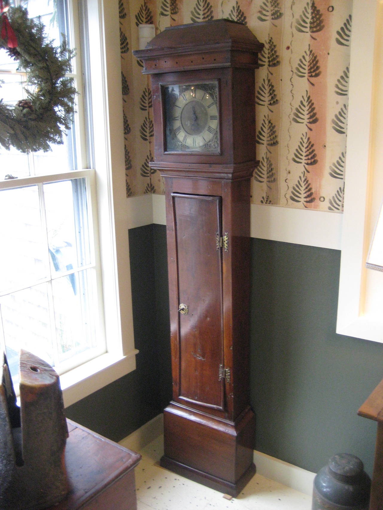 English yew wood tall case clock with narrow proportions.