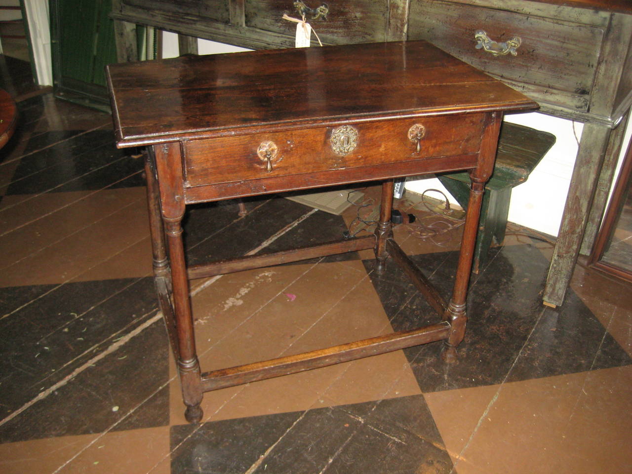 English oak side table with drop pulls and stretchers.