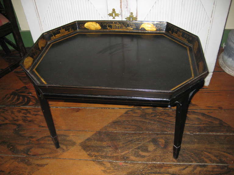 English black and gold painted tin tray table with oriental  motif on stand.
