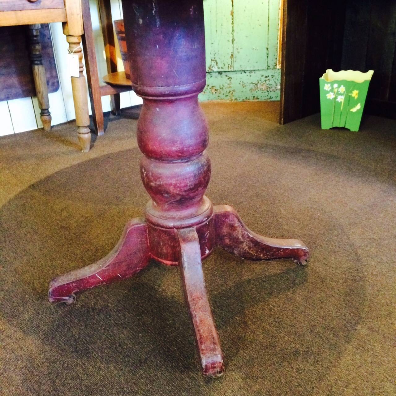 Pedestal dining table in original red paint.