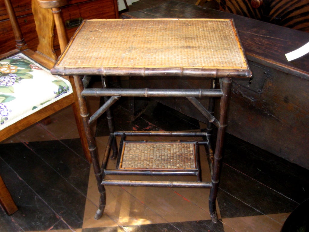 English two-tiered cane and bamboo side table