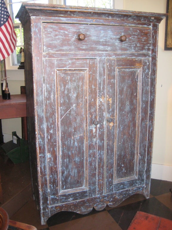 Pine armoire in original paints with panelled doors and shaped skirt.