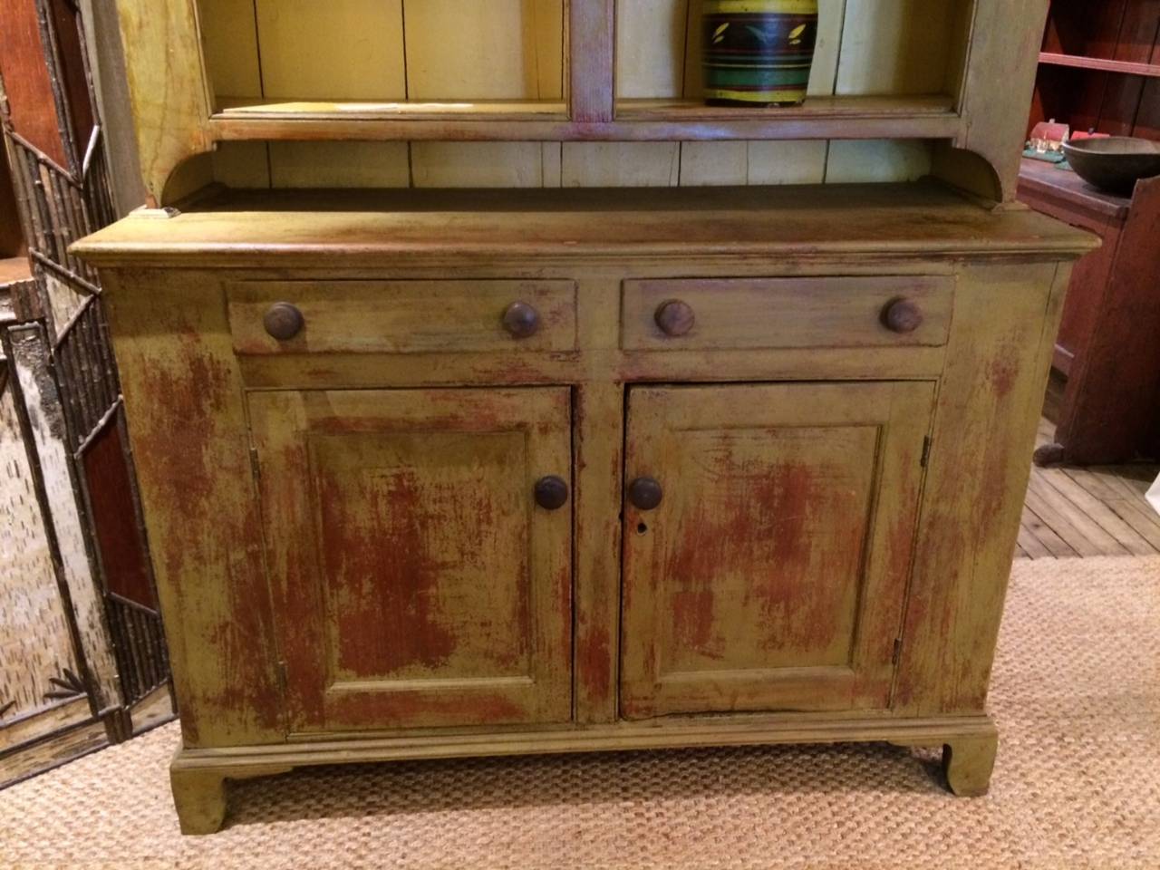 Two piece American stepback cupboard in mustard paint.  Likely Pennsylvania or Ohio origin.  Minor chips on base of top on left and top left cornice.  Interior repaint.