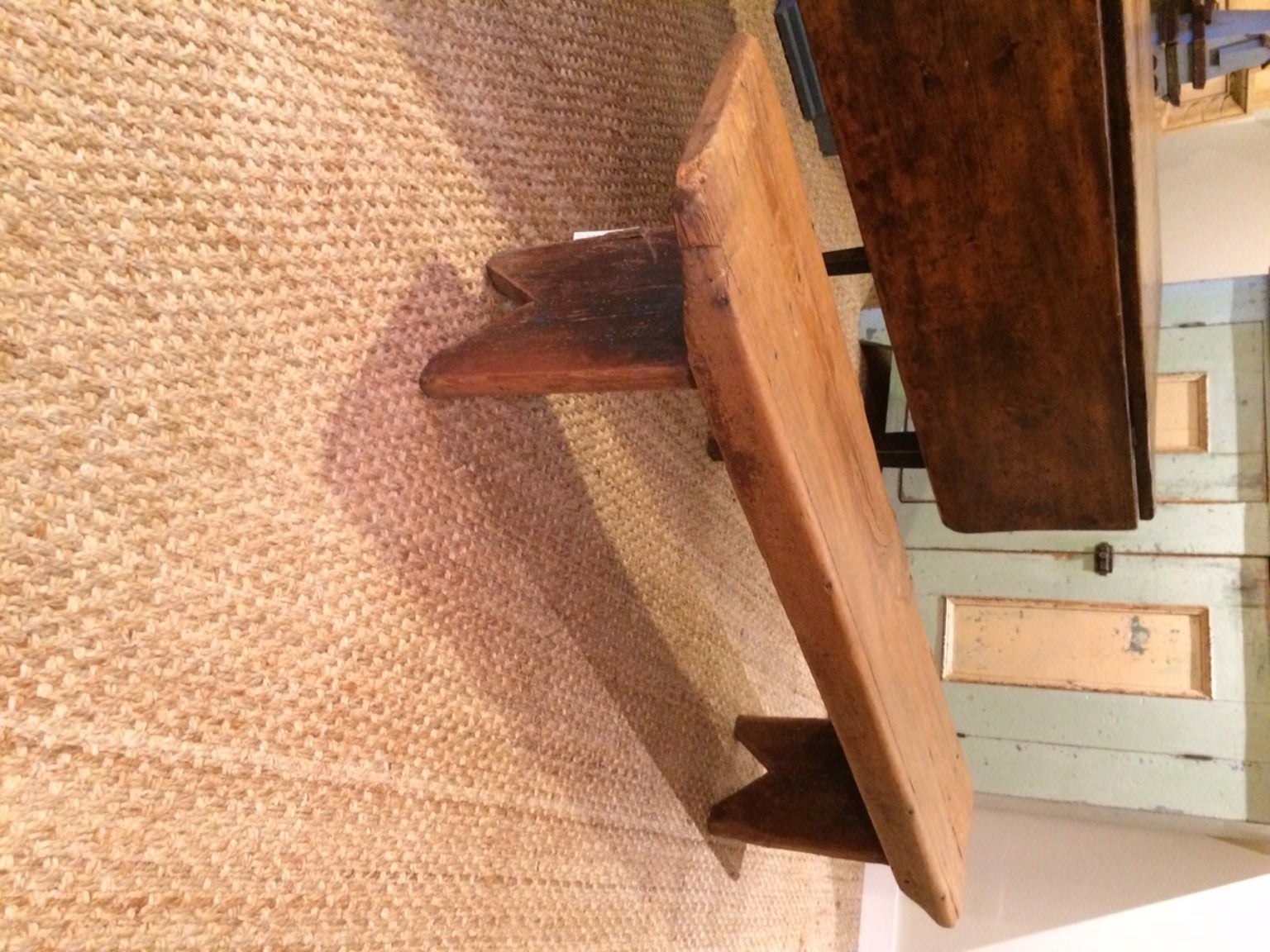 Pine bench with original brown paint.  Bootjack ends and square nail construction.