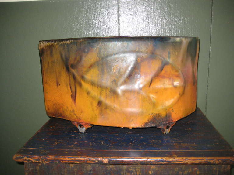 Large glazed pottery in the shape of a leaf fired in the Japanese process called Raku.  Warm colors reminiscent of fall. One of a kind ceramic.