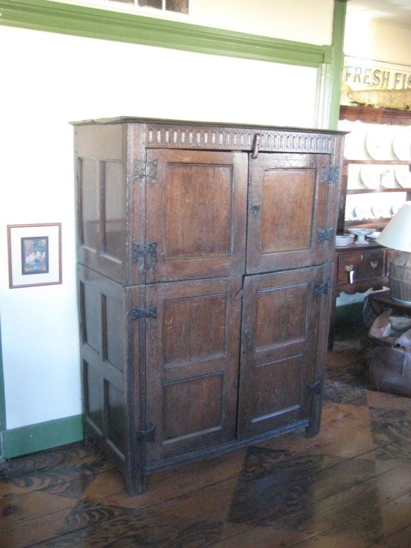 Four-door Cupboard with shelves inside, paneled sides, and carved detail