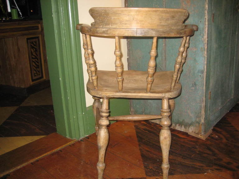 19th Century American white oak captain's chair.  Previously painted back.  Some remnants around the base of the spindles.