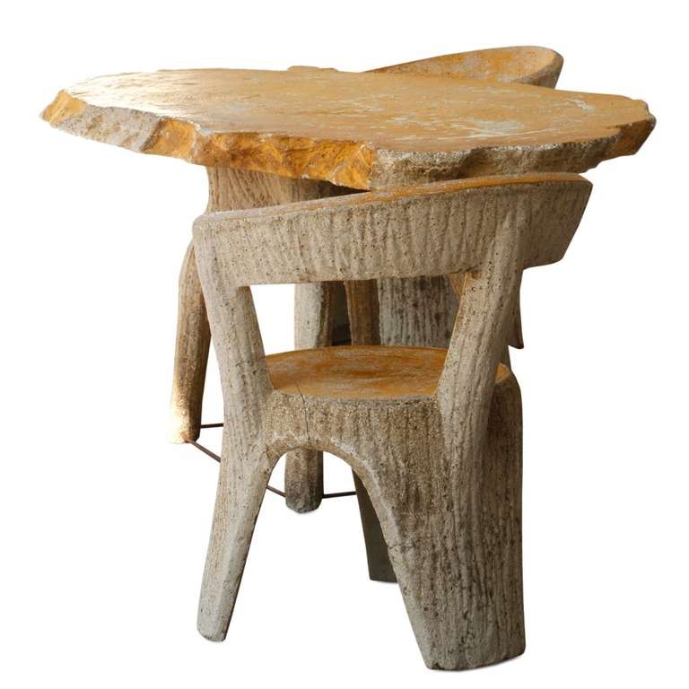 Made in the style of faux bois, a method which resembles the texture of wood grain, this patio set is crafted from solid cement. Besides its unique old world charm and classic design it's incredibly durable and guaranteed to last.