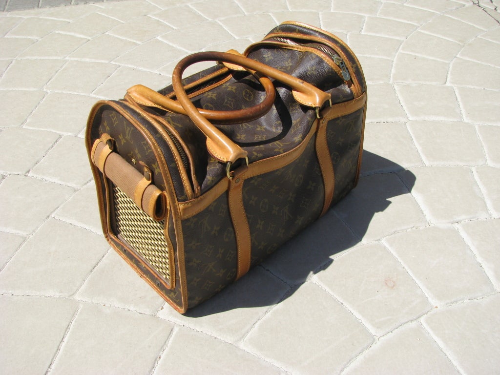 Louis Vuitton Dog Carrier, 40 M42024. Carrier is in good used condition, and interior is very clean. 
Any signs of normal usage such as handles, etc., should be visible in photographs, and more pictures can be provided if necessary.