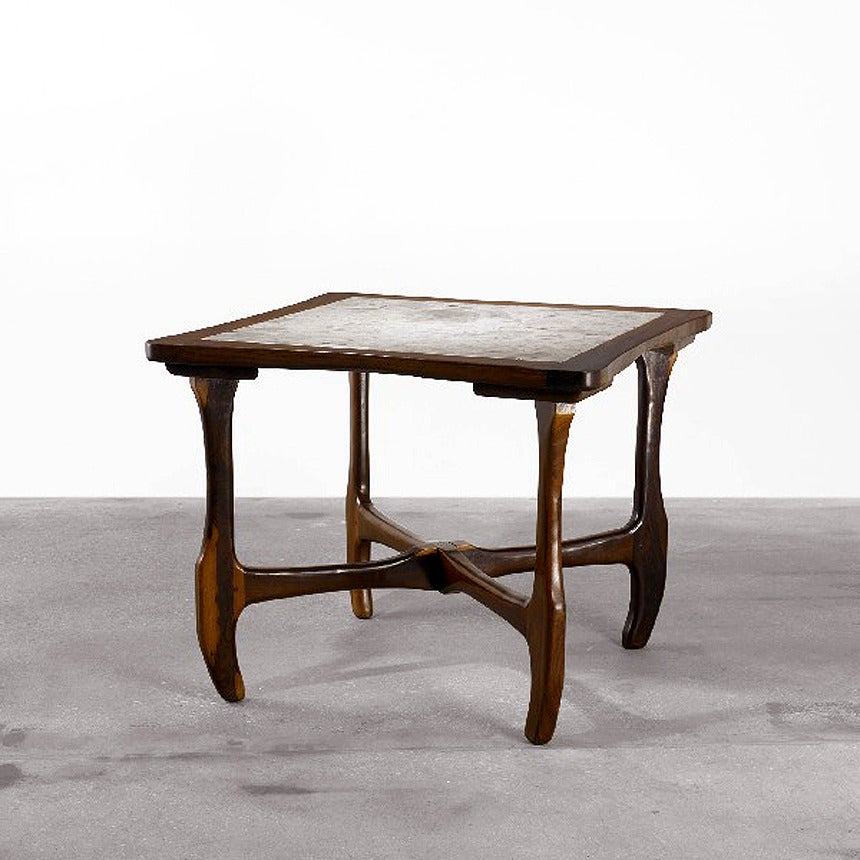 A square dining or game table by Don Shoemaker for Senal, Mexico, circa 1970. Solid Mexican rosewood Cocobolo frame with carved organic forms and joints. Marble top inset with natural veins. 
Retain an early partial label of the manufacture