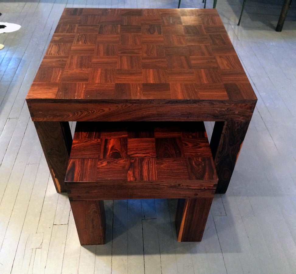 A set of two nesting tables made by Don Shoemaker for Señal, Mexico, circa 1960s. Heavy cubist construction with minimalist form and exposed dove joins and point joints. The surface is veneered with parquetry patches of Mexican rosewood Cocobolo.