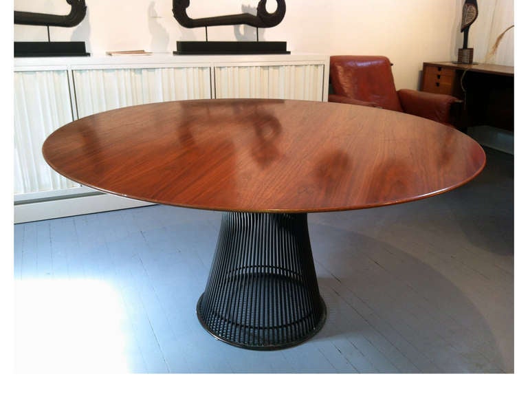 A stunning vintage round dining table designed by Warren Platner for Knoll produced circa 1970s. It features a bronze coated steel base and a walnut wood top. Great mellow patina throughout and expressive grains.