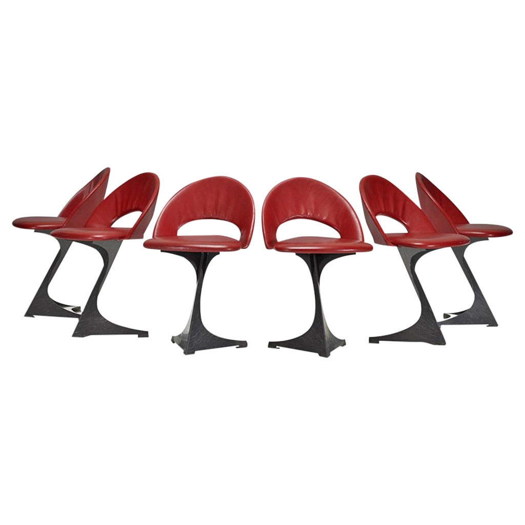 A set of highly sculptural pedestal chairs in red leather designed by architect Santiago Calatrava and manufactured by De Sede for the famed Tabourettli Theatre in Basel, Switzerland. In 1986, Calatrava designed these chairs for the most famous