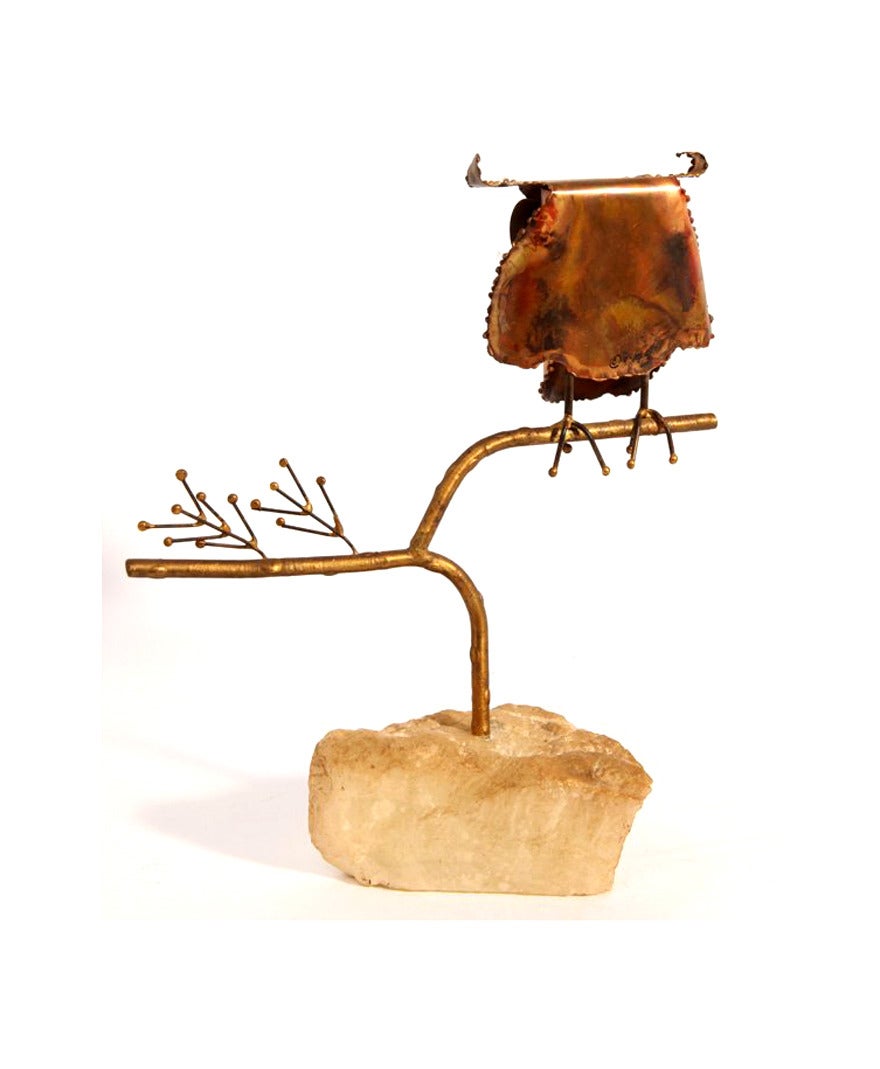 A small but sweet table top sculpture by C. Jere circa 1967. Made of brass with enamel eyes and installed on a natural onyx rock.  table top sculpture. Signed and dated 67.
