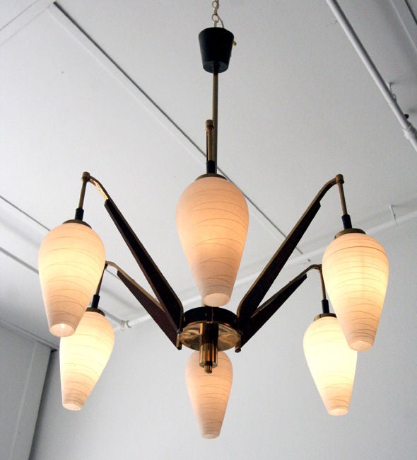 A beautiful mid-century chandelier from Italy, attributed to Stilnovo production in 1950s. Brass center rod, Six brass and enameled steel arms with teak accent extend to six hanging glass pendants. Great presence from all angels. Only the second one