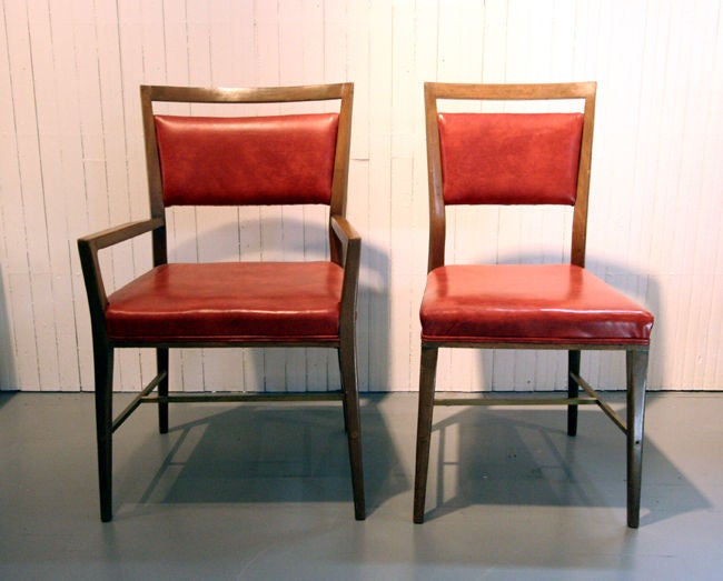 A set of six ding chairs designed by Paul McCobb as part of the Directional line. Solid bleached mahogany frame with brass stretch bars and upholstered in a burnt orange stimulated leather. Five side chairs and one master arm chair.