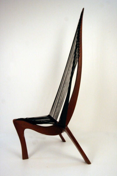 A nice vintage Harp chair was likely designed by Jorgen Hovelskov and manufactured by Christensen & Larsen, Mobelhadvaerk, Copenhagen in 1960s. Its unique form was inspired by a Viking ship bow section. The expertly crafted frame, in solid walnut,