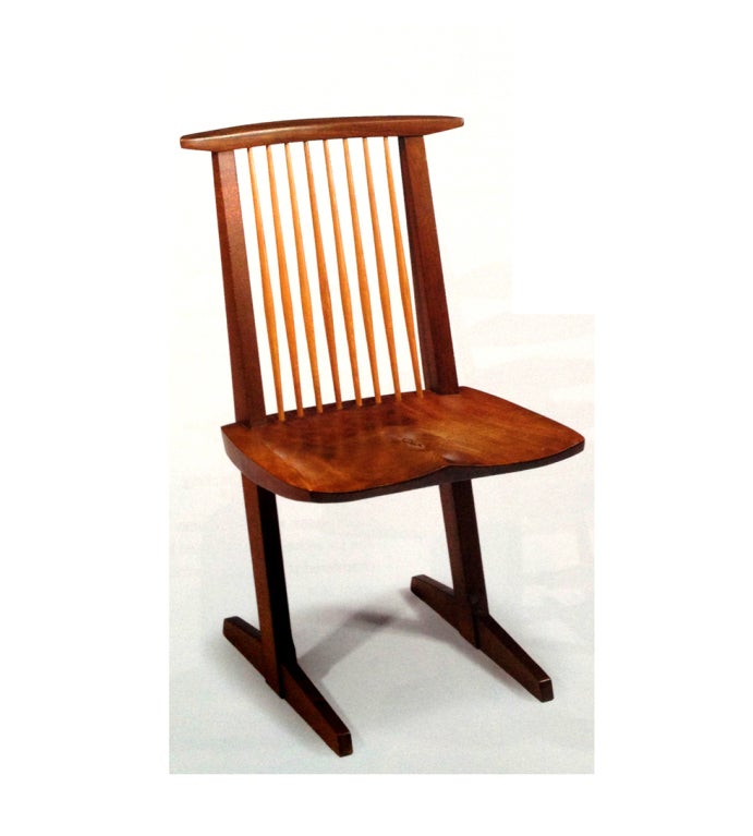 A single walnut conoid side chair designed and made by famed cabinet maker george nakashima in 1980. The seat has beautiful grains and it is inscribed, 