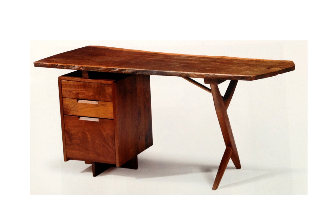 A stunning cross-legged desk made by famed woodworker George Nakashima. A custom made piece that features an unusual Laurel wood plank top that has expressive grains, free edges and an ebony butterfly at one end. Three drawers on cross pedestal