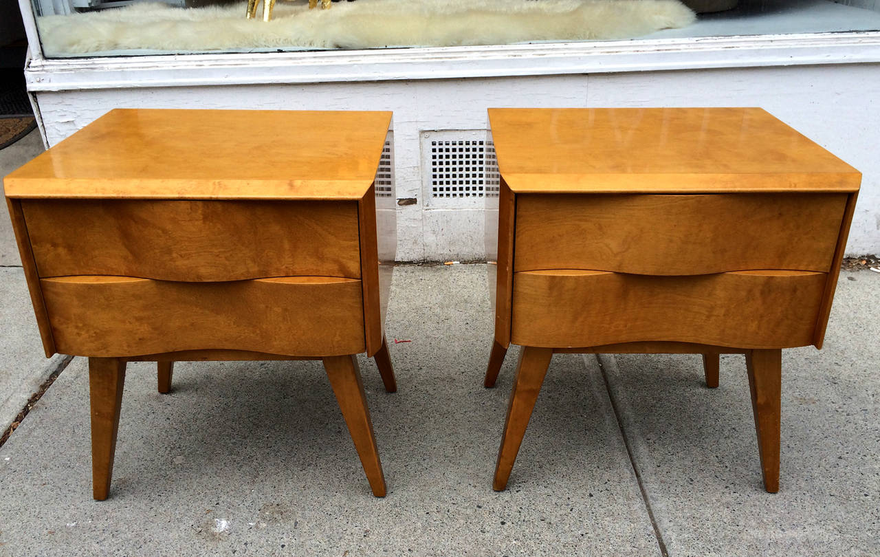 A very savvy pair of Mid-Century Modernist nightstands designed by Edmond Spence, circa 1950s, en suite with a matching tall dresser with accordion door and a double long dresser. This series features an architectural undulating facade and the