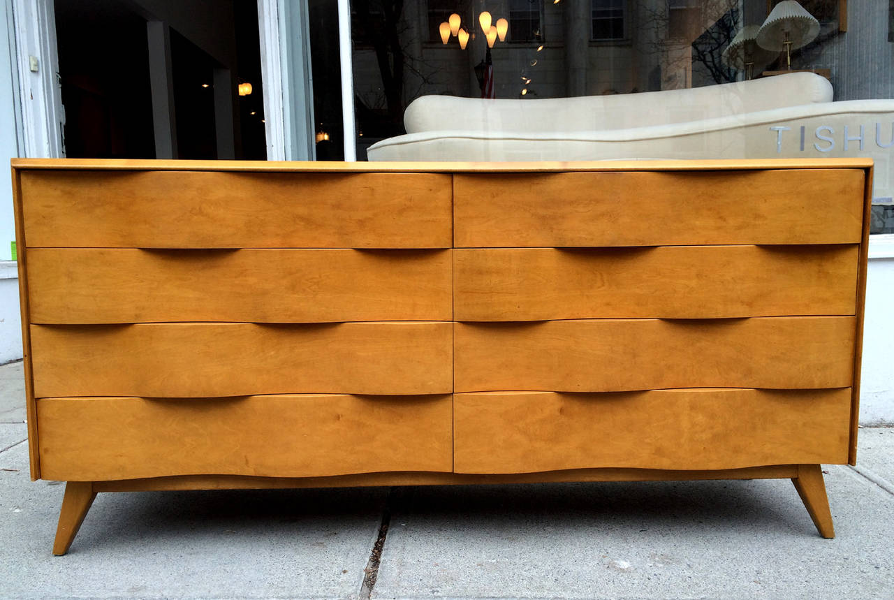 A very savvy Mid-Century Modernist dresser designed by Edmond Spence circa 1950s, en suite with a matching tall dresser with accordion door and a pair of nightstand. This series features an architectural undulating facade and the organic form is