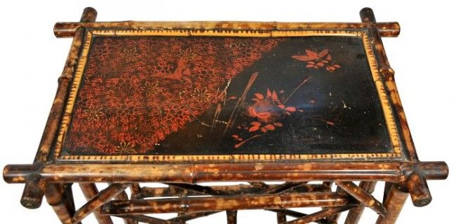 A Regency Bamboo Canterbury likely from 19th Century, likely English. It is used to function as a music stand at its time. It can also be used as a magazine rack and a great accent side table. The top is decorated with Chinoiserie Lacquer depicting