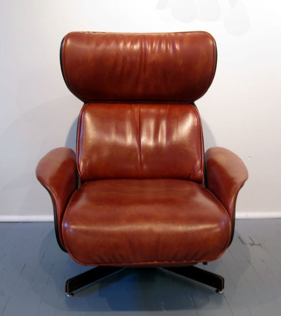 Unusual model of a lean back recliner with foot rest manufactured by Plycraft in MA. Circa 1960. Walnut lamination body and beautiful pumpkin brown stimulated leather upholstery. Extremely functional and comfortable. Nice warm patina on leather.