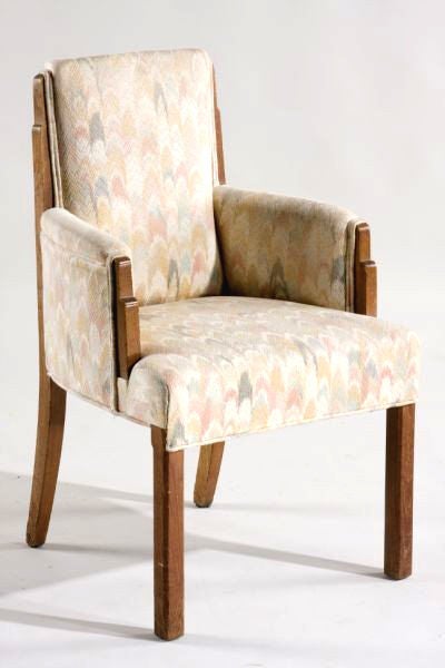 A large and gorgeous set of Art Deco chairs circa 1930s. Solid oak frame with carved tiered skyscraper details along the back and armrest. Beautiful Silhouette that reflects the aesthetic and spirit of the Art Deco era. They are covered with with an