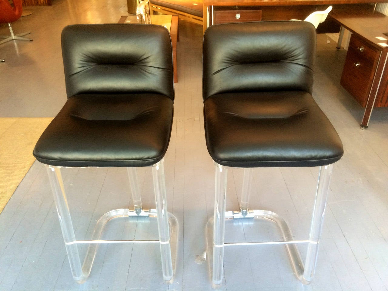 A pair of high chair or bar stools designed by Lion in frost circa 1970s. Thick lucite tubular frames with the signature T shape chromed metal connecting hardware in the back, these chairs are functional and elegant-looking from all angels. The