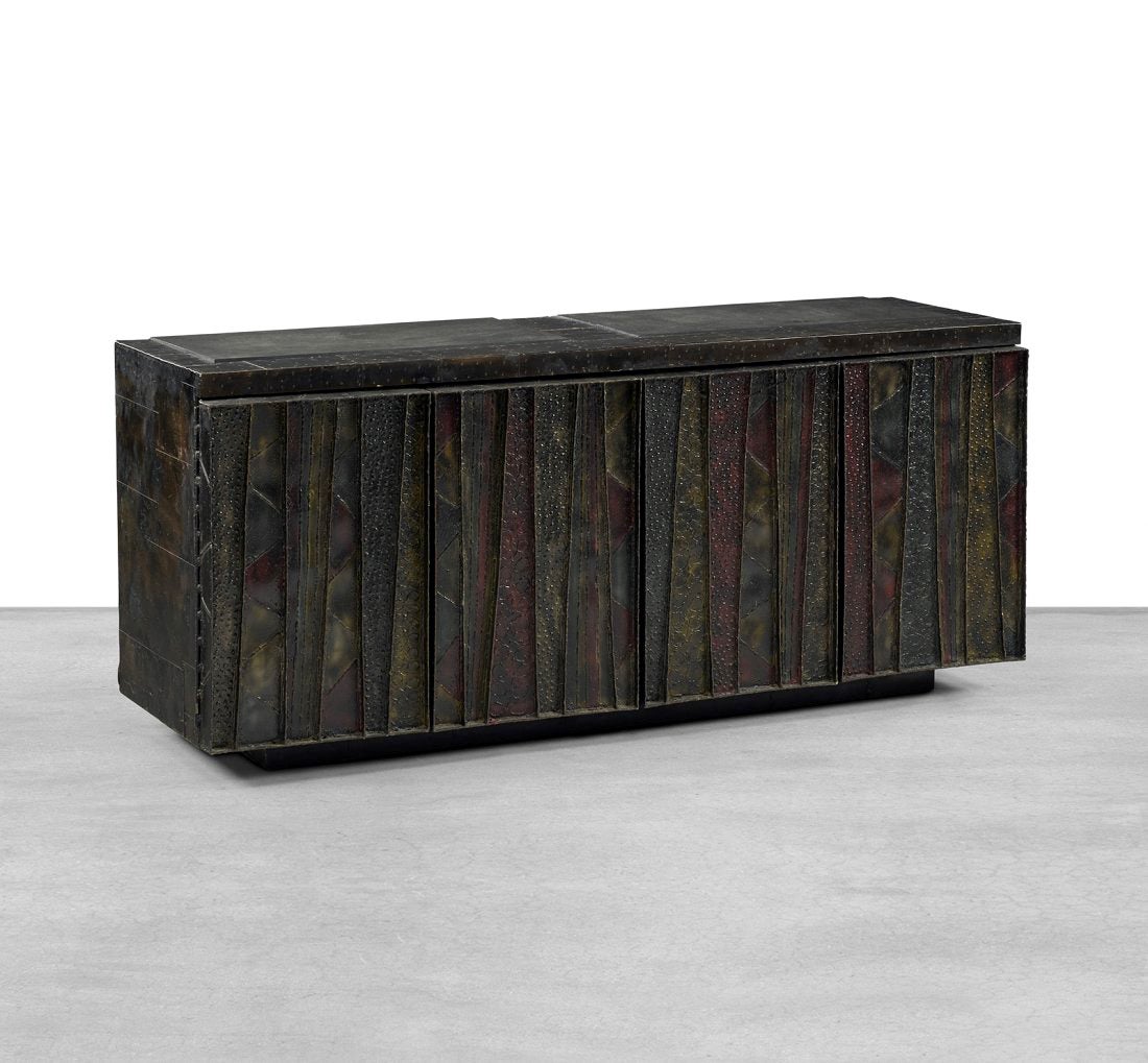 A stunning sculpted-front credenza cabinet by Paul Evans, model PE 40A, made in 1974 in his studio for Directional. Constructed from welded steel on the front, patchwork metal sidings and slate tops, this cabinet features an enameled decorated front
