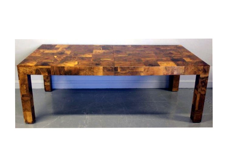 A large extension dining table by Paul Evans from Directional. It is an artistically display of the patchwork of burl veneers that is the signature of the Paul Evans' style. It still retains its original metal tag 