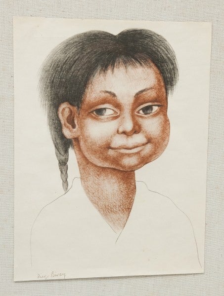Pair of vintage prints of Diego Rivera's drawings of indigenous Mexican children. Framed on linen board in a pair of period frame. In print signature. Print size is 10