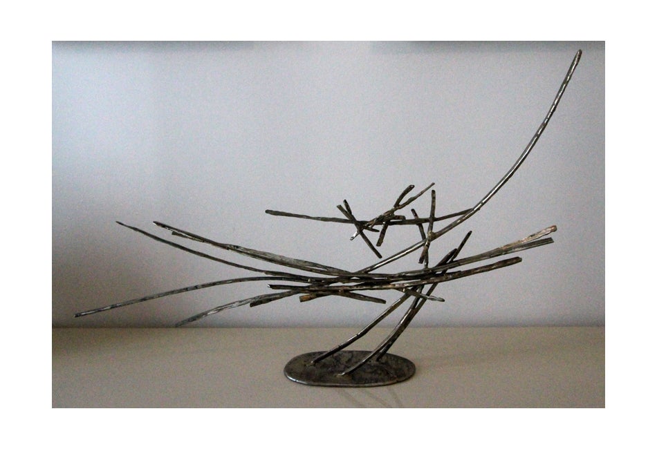 A free form abstract studio sculpture hand crafted by Silas Seandel. It was welded in his signature style with stacked steel rods and finished in an antique bronze surface with hammered effect. Signed on base with engraved signature 