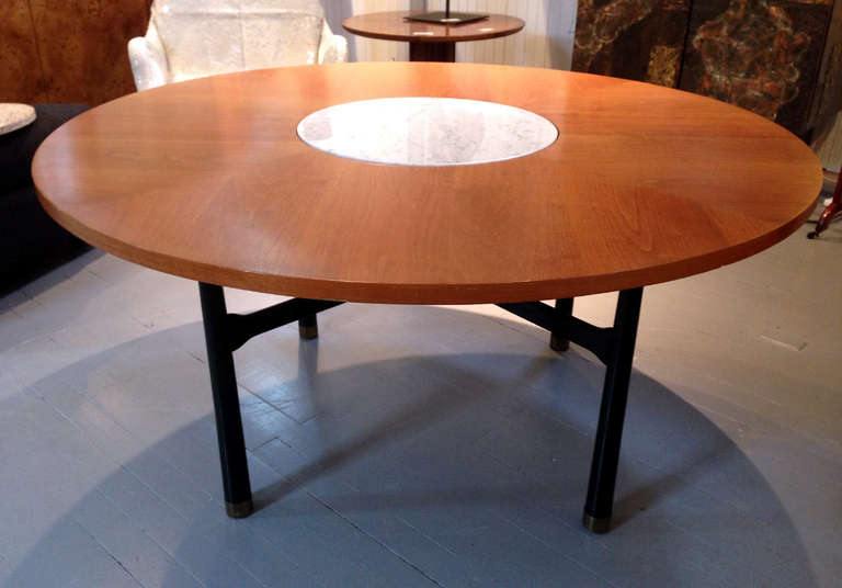 A round center or occasional table by Harvey Probber for Harvey Probber, Inc. circa1958. The walnut top feature a central insert and two stone discs are available as terrazzo and marble. The legs are lacquered ebony color with cross stretcher and