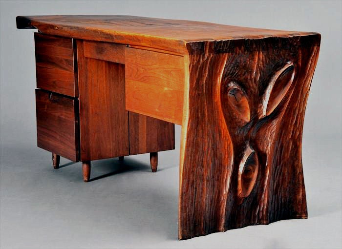 Stunning desk made of Walnut by Phillip Lloyd Powell (1919-2008). The free-form surface is made of thick walnut plank and decorated with two rosewood butterflies. One side of the desk is hand-chiseled in a signature Phillip Powell style. It has all
