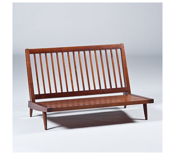 A custom made armless settee purchased directly from George Nakashima Studio at New Hope PA. With two loose cushions newly recovered in an ivory color wool fabric 