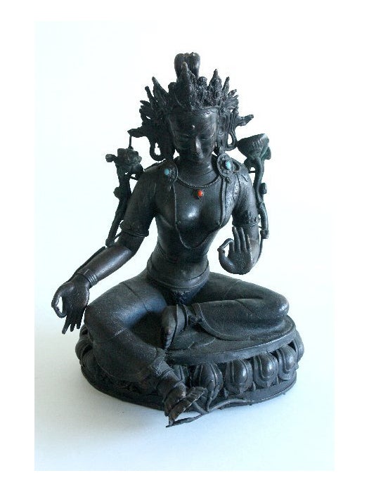 A bronze bejeweled statue of Tara