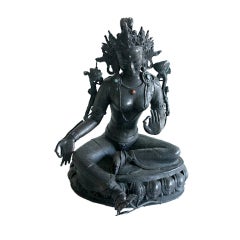 A bronze bejeweled statue of Tara