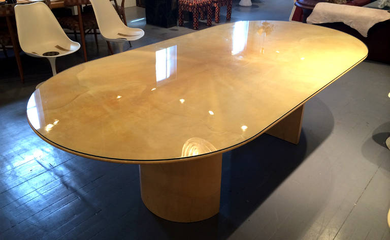 A large stunning dining table by Karl Springer, circa 1970s. Beveled top with rounded corners is supported by two semi circular pedestal base. Completely clad with lacquered goat skin. Simple form that showcases the luxury material and superb