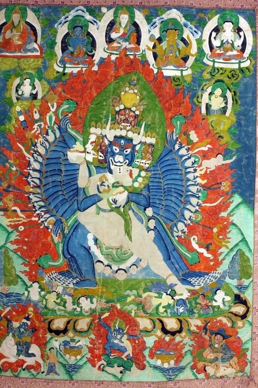A stunning antique Tibetan Thangka with an embroidered border, circa mid to late 19th Century. It depicts Yamantaka or Vajrabhairava, a wrathful manifestation of Manjusri, the bodhisattva of wisdom, and in other contexts functions as a dharmapala,