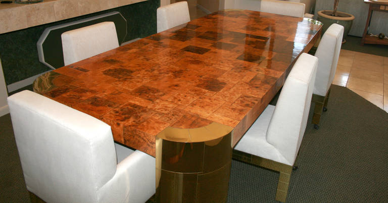 A fantastic Curvilinear dining table by Paul Evans for Directional circa 1970s. Model PE-509 with Olive Burl wood patchwork contrasting the shades of brass. Heavy and substantial, the table features four brass veneered legs and two removable central