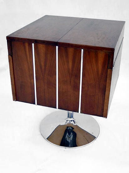 A beautiful pedestal bar made of Walnut and Chrome by Lane. The top opens to reveal a bi-folded wing-tray and a storage with a removable bottle holder. The walnut case can be swiveled to any direction. In addition to a bar, it can be used as a side