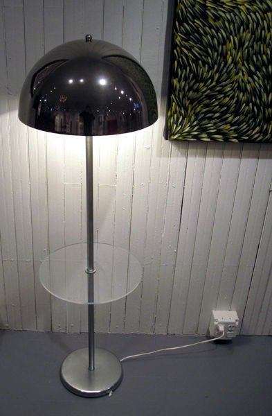 One floor lamp designed and manufactured by Nessen Studio. Chrome finish with chrome shade and a Lucite tray table attached. Labelled Nessen.
Labelled Nessen Studio, NY.
 