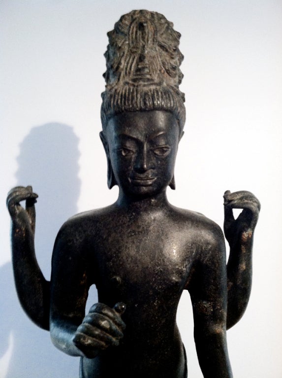 Cast in Bronze, this Avalokitesvara Statue is from Thailand with conspicuous influence from neighboring Khmer culture in nowadays Cambodia, where Hinduism and Buddhism confluent. Avalokitesvara is one of the most revered Bodhisattvas in Mahayana