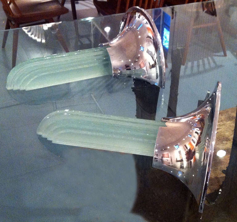 Designed by Karl Springer(1931-1991), these pair of Percell wall sconces epitomize the glamor of 70s. With a nostalgic touch of Art Deco and Hollywood Recency, the chrome vessels beautifully contrast the icicles formed by a cascade of geometrically