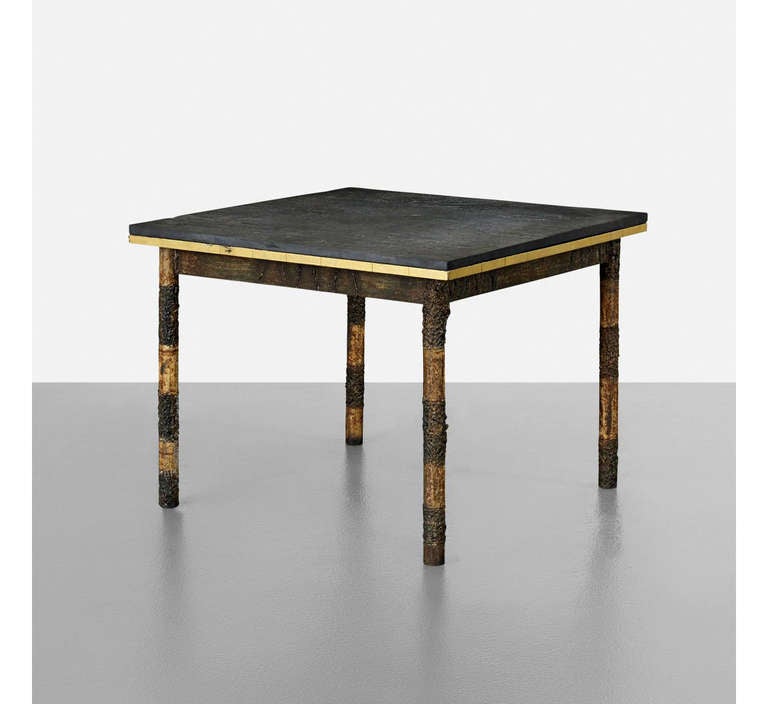 A metal frame center or occasional table studio crafted by Paul Evans. An early piece dated in 1960s likely from the shared studio with Philip Lloyd Powell in New Hope, PA. It has a distinguished brutalist flare with the patinated steel frame that