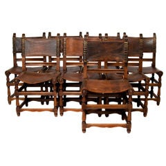 A Set of Eight Walnut and Leather Studded Dining Chairs